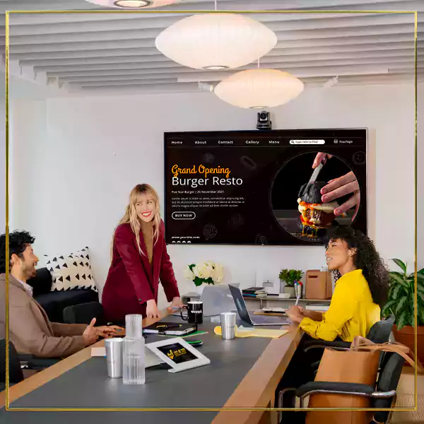 Professionals collaborating in office, framed by letter-shaped windows